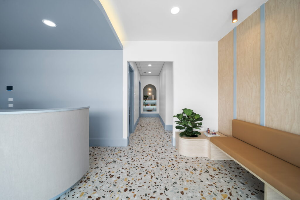 Accessible healthcare reception with lowered counter, open pathways and generous circulation space