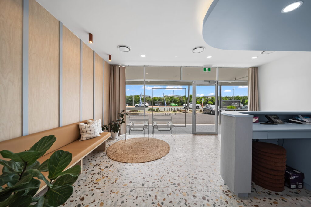 Healthcare reception and waiting area with step-free entry, accessible pathways and open patient circulation