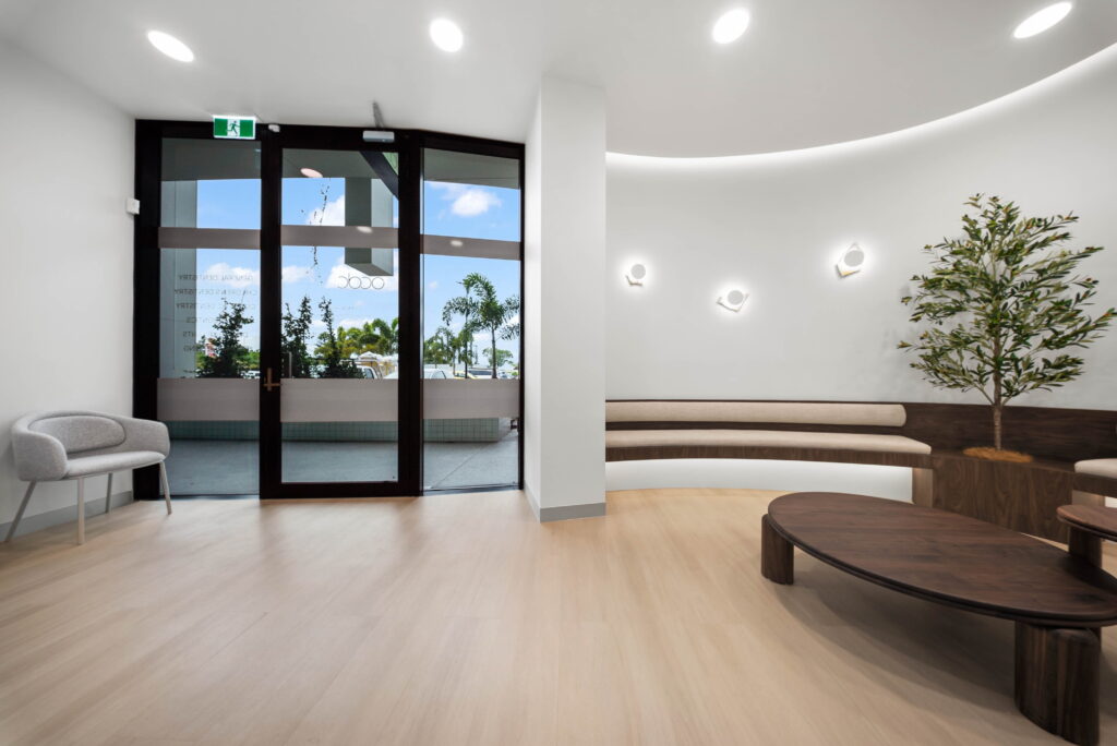 Modern healthcare waiting area with open circulation space, accessible entry and integrated patient seating