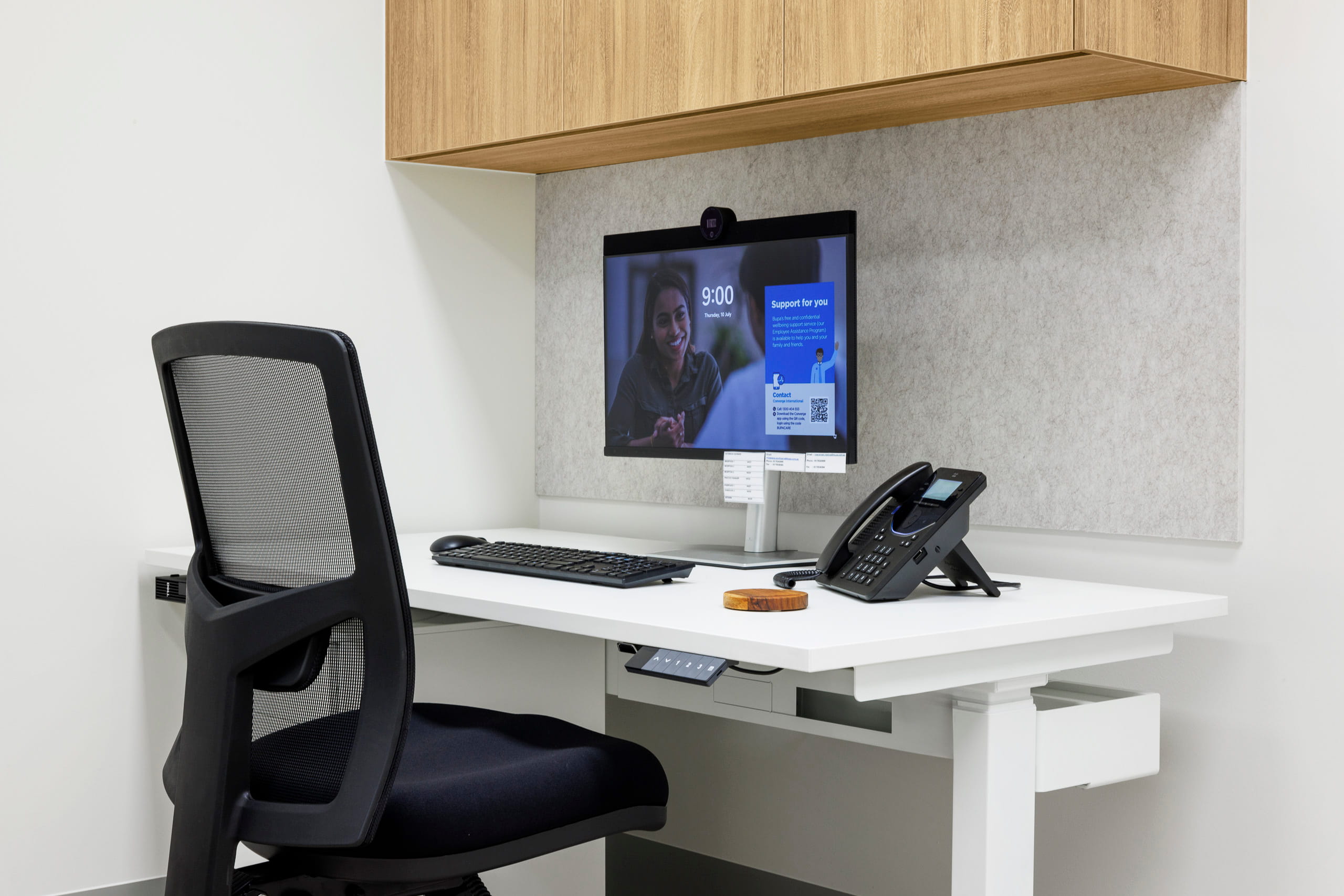 Height-adjustable workstation with computer and overhead storage in a medical clinic