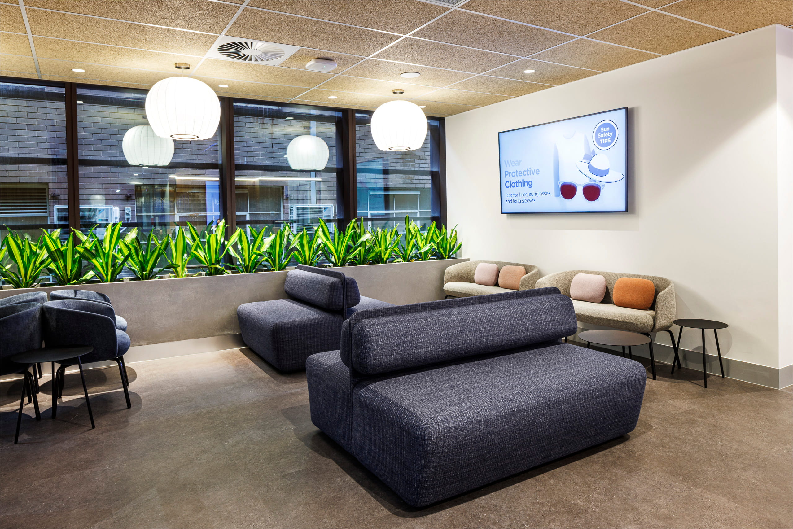 Medical clinic waiting area with open circulation space and varied seating
