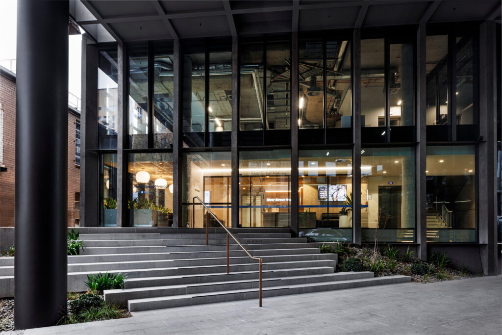 Street-level entrance to River Street Medical with stairs and handrails
