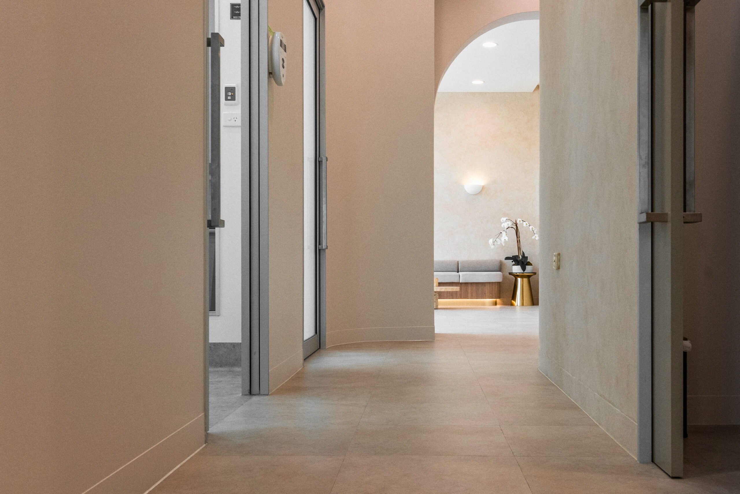 Wide clinic corridor leading to a patient waiting area