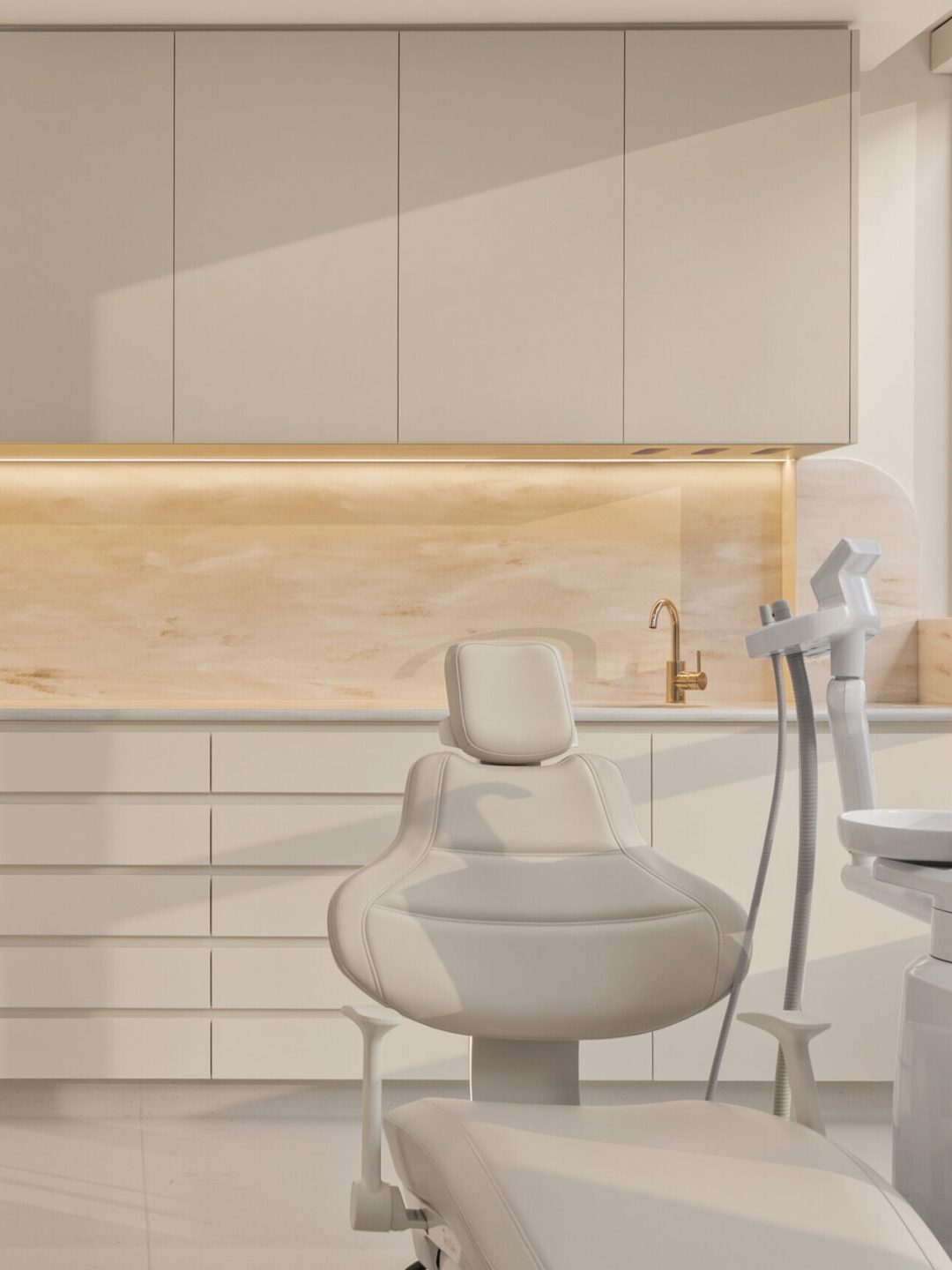 Dental treatment room with dental chair, wall-mounted imaging equipment and built-in cabinetry